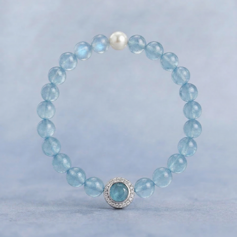 AETHER Key: FLOW aquamarine bracelet with pearl and silver pavé focal bead, translucent blue jelly-grade crystals on a soft blue background.