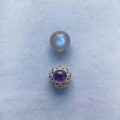 Macro detail of AETHER Key: INTUITION, showing a labradorscent flash bead and the 925 silver orb inlaid with purple charoite, green opal, and red garnet.