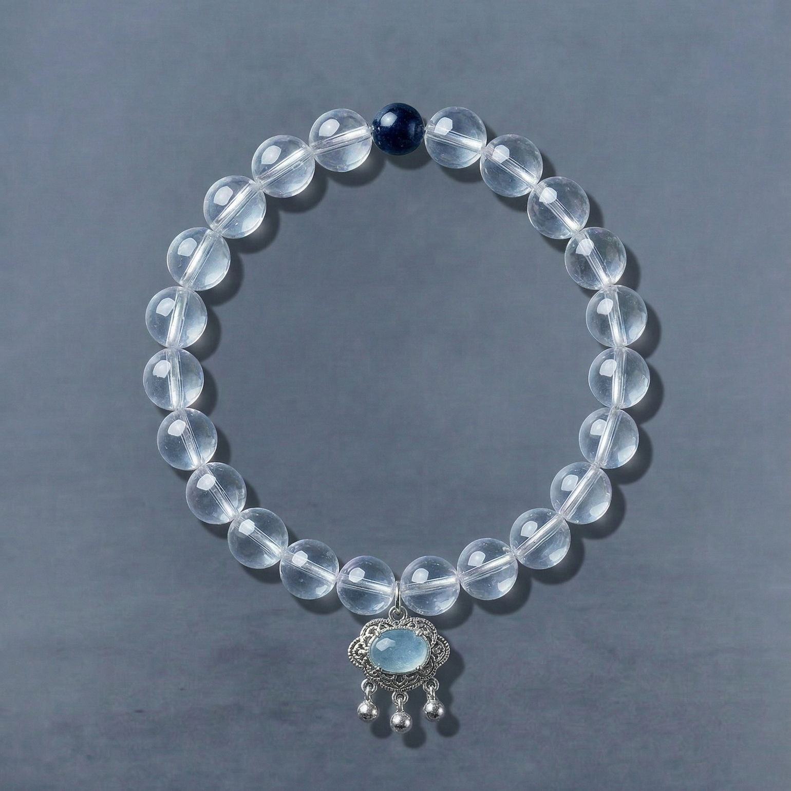 AETHER clear quartz bracelet with transparent beads and a dark blue focal detail