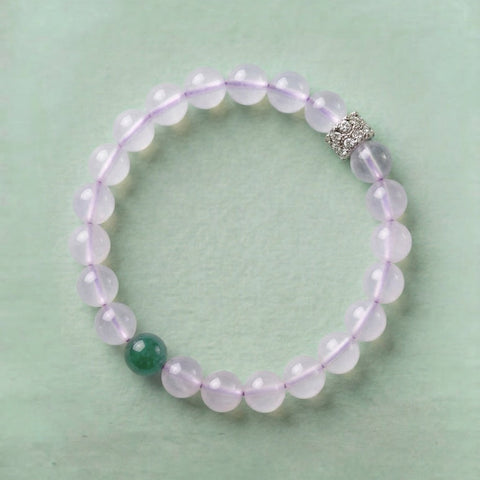 AETHER Key: INTUITION white moonstone bracelet with emerald green jadeite accent and silver pavé spacer, milky white translucent beads on a soft sage green background.